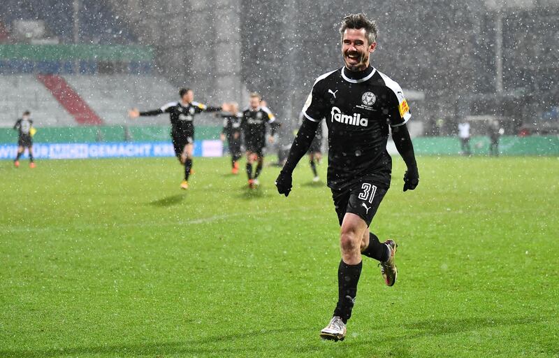 Fin Bartels of Holstein Kiel celebrates after winning the shootout at Wunderino Arena. Getty