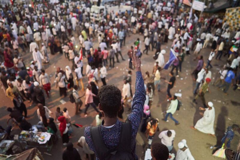 A protester chants and raises the peace sign. Getty Images