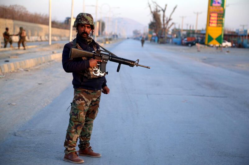 epa09005139 An Afghan soldier stands guard at the scene of a bomb blast that targeted vehicle of security officials in Jalalabad, Afghanistan, 11 February 2021. Afghanistan's major cities have been witnessing an increase in violence and targeted killings over the past one year, especially since the signing of a peace agreement between the United States and the Taliban in February last year.  EPA/GHULAMULLAH HABIBI