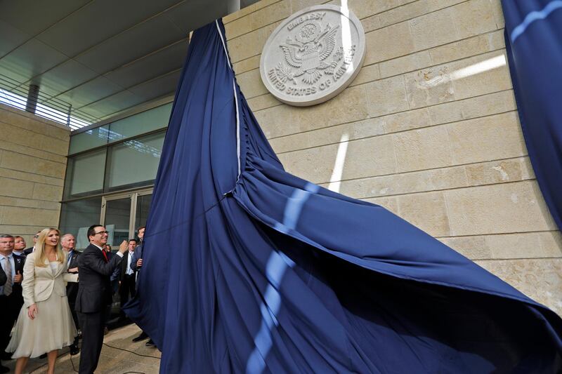 US Treasury Secretary Steve Mnuchin and US President's daughter Ivanka Trump unveil an inauguration plaque during the opening of the US embassy in Jerusalem on May 14, 2018. - The United States moved its embassy in Israel to Jerusalem after months of global outcry, Palestinian anger and exuberant praise from Israelis over President Donald Trump's decision tossing aside decades of precedent. (Photo by Menahem KAHANA / AFP)