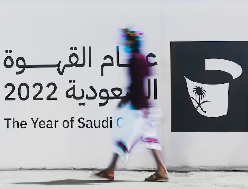 Man walks past hoarding advertising the ‘Year of Saudi Coffee’. Photo: Ministry of Culture