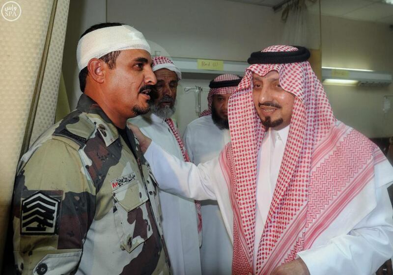 The governor of Asir province, Prince Faisal bin Khaled bin Abdulaziz, greets a soldier who was wounded in a suicide bombing attack on a mosque inside a police compound in the provincial capital of Abha. Saudi Press Agency via AP