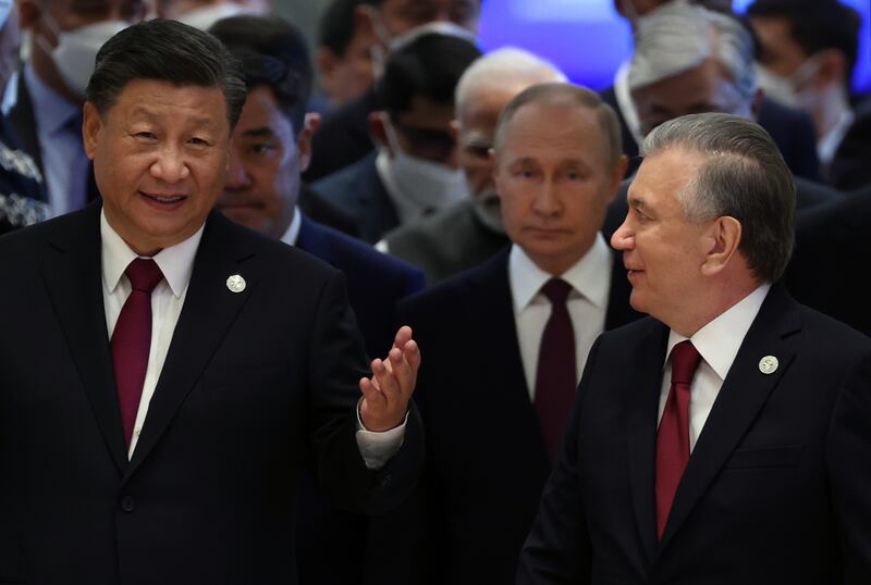 From left, Mr Xi, Mr Putin and Mr Mirziyoyev arrive at the  summit in Samarkand. EPA