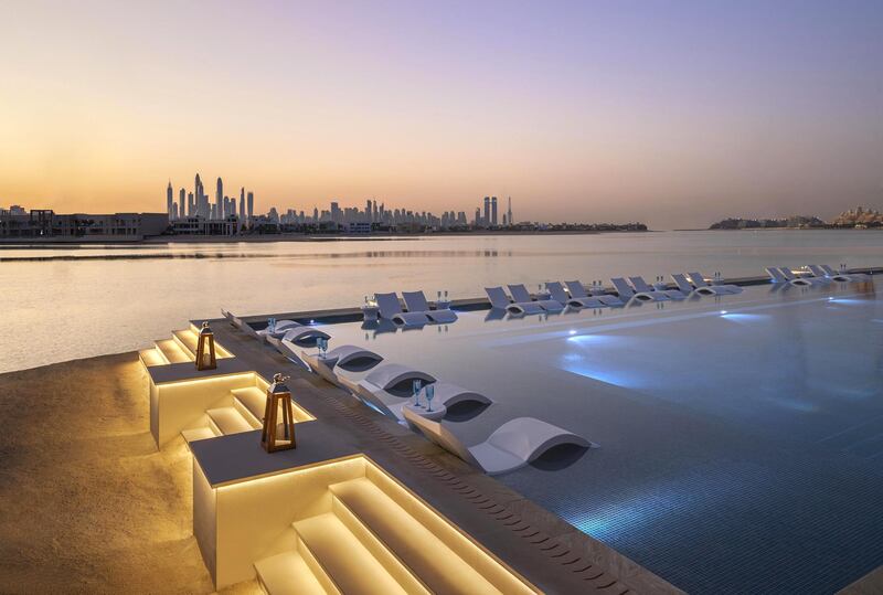 Perch on sun loungers immersed in water at White Dubai in Atlantis, The Palm, Dubai.