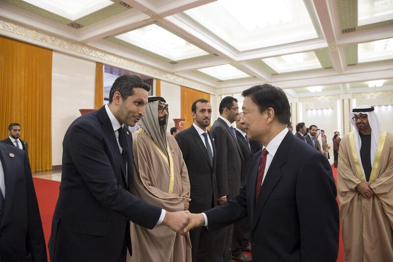 Sheikh Mohammed bin Zayed, Crown Prince of Abu Dhabi and Deputy Supreme Commander of the Armed Forces, looks on as Khaldoon Al Mubarak, chief executive of Mubadala Development Company and Chairman of the Abu Dhabi Executive Affairs Authority, greets Chinese vice president Li Yuanchao at the Great Hall of the People in Beijing on Monday. Mohamed Al Hammadi / Crown Prince Court – Abu Dhabi