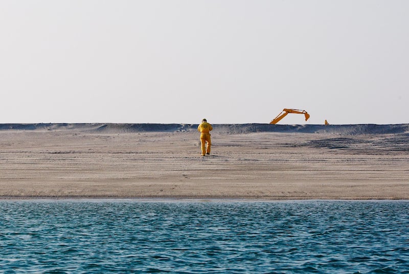 Dubai - November 25, 2008: A man walks from a construction site on the the Palm Jebel Ali. ( Philip Cheung / The National ) *** Local Caption ***  PC0412-PalmJebelAli.jpgPC0412-PalmJebelAli.jpg