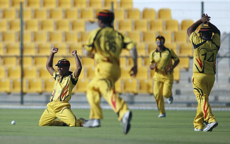 Norman Vanua, of Papua New Guinea cricket team, celebrates after taking a catch to dismiss Laxman Sreekumar of the UAE during the T20 cricket match between UAE and Papua New Guinea at Sheikh Zayed Cricket Stadium in Abu Dhabi. Ravindranath K / The National