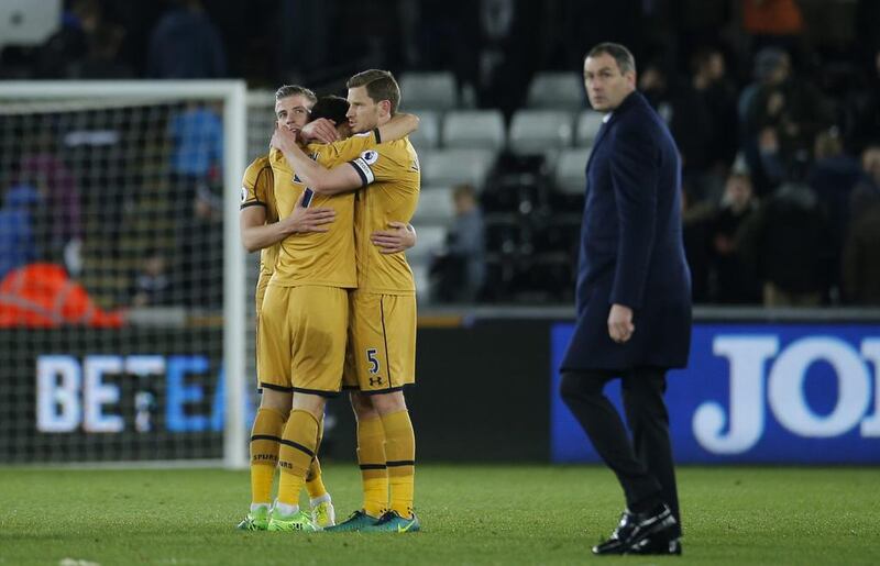 Tottenham's Toby Alderweireld, Son Heung-min and Jan Vertonghen celebrate as Swansea City manager Paul Clement looks dejected. Andrew Couldridge / Reuters