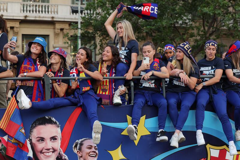 Barcelona's women's team midfielder Alexia Putellas, centre, and the rest of players parade aboard an open-top bus to celebrate their fourth consecutive Liga F title win, in Barcelona. AFP