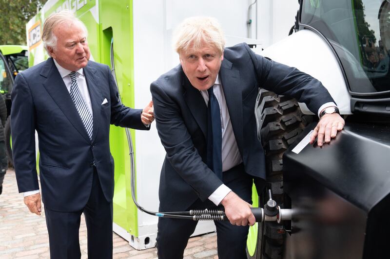 UK Prime Minister Boris Johnson and JCB chairman Lord Anthony Bamford at the unveiling of a hydrogen-powered telescopic handler in London ahead of the Global Investment Summit. PA