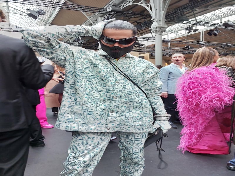 This man in an outfit printed with dollar bills at Valentino.
