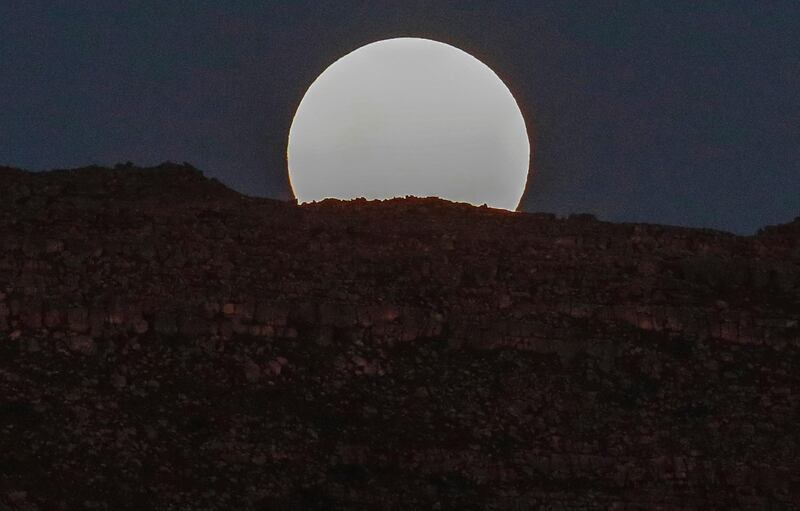 A Supermoon rises over the World Heritage Site Table Mountain National Park in Cape Town, South Africa. Nic Bothma / EPA