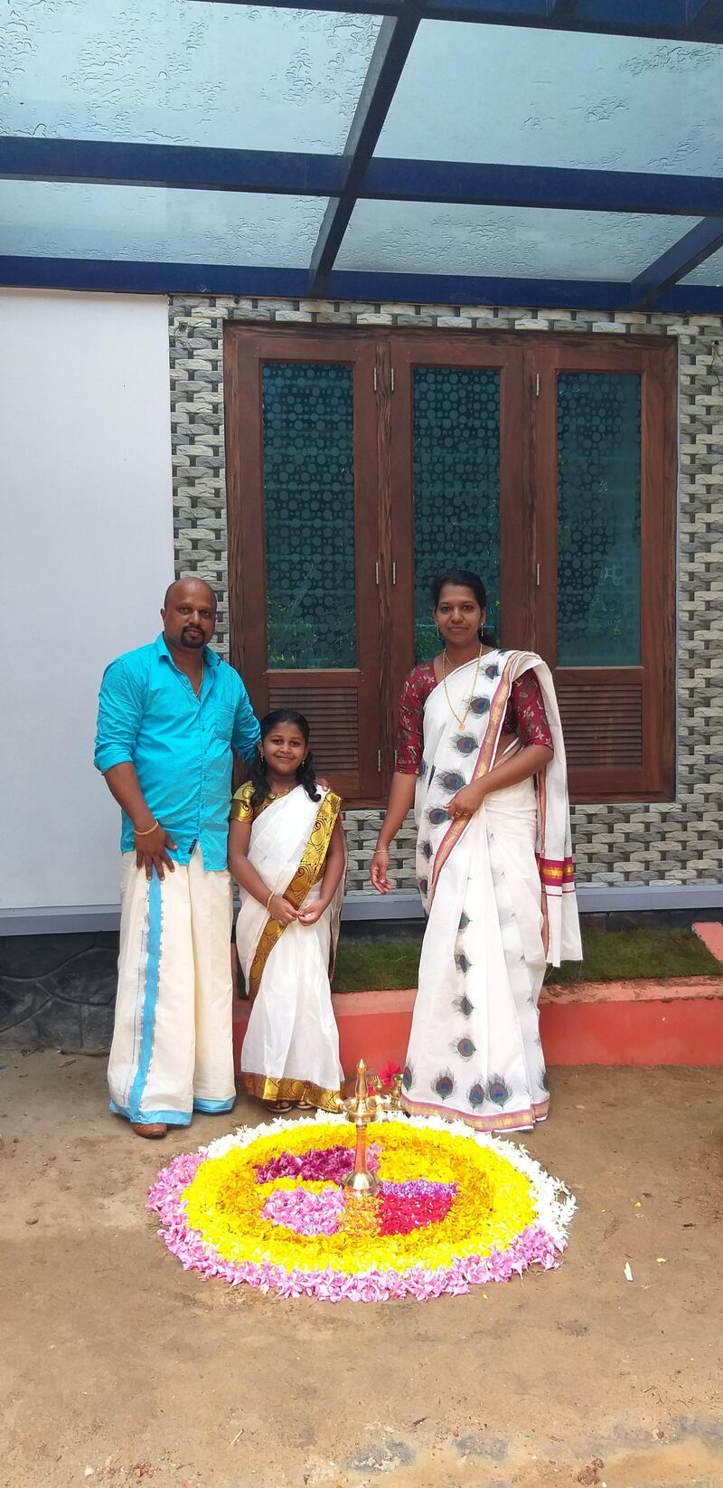 Soumya Devi, her husband Hari Prasad and their elder daughter Bhadra in their hometown of Kerala in southern India. The family tells of home amid the coronavirus pandemic. Courtesy: Hari Prasad