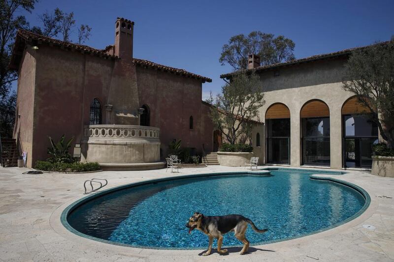 A dog walks past the swimming pool outside the former home of Sisters of the Most Holy and Immaculate Heart of the Blessed Virgin Mary on Waverly Drive in the Los Feliz neighborhood of Los Angeles. The eight acres, with panoramic views and a villa, could wind up as either a boutique hotel or a home for Perry. Patrick T. Fallon / Bloomberg