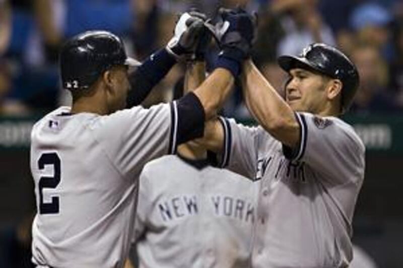 New York Yankees' Derek Jeter, left,  congratulates Johnny Damon after his  three-run homer.