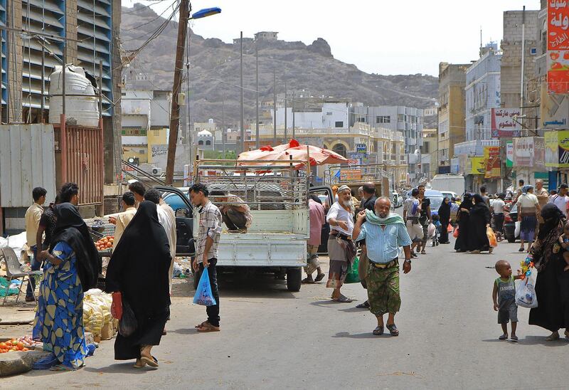 People walk and shop along a market street in the Crater district in the centre of Yemen's second city of Aden. AFP