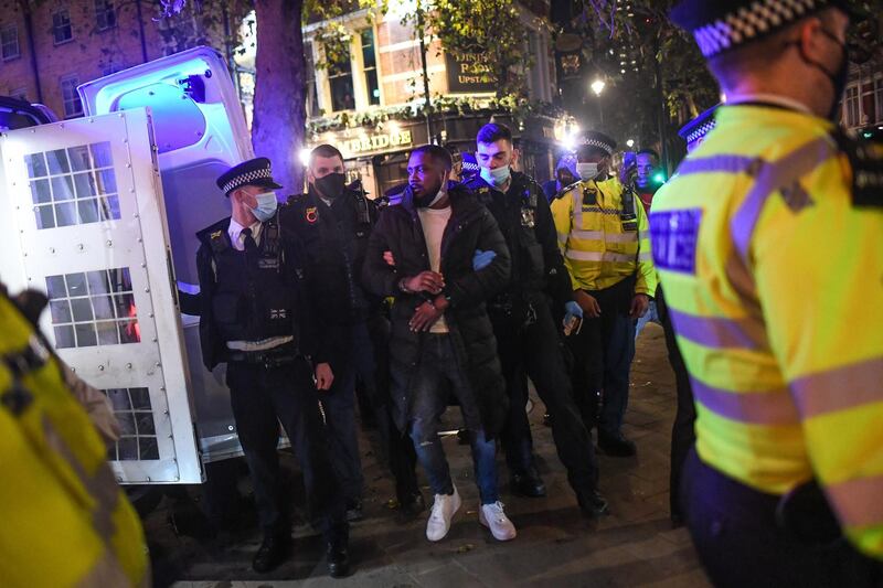 Police officers arrest a man in Soho. Getty Images