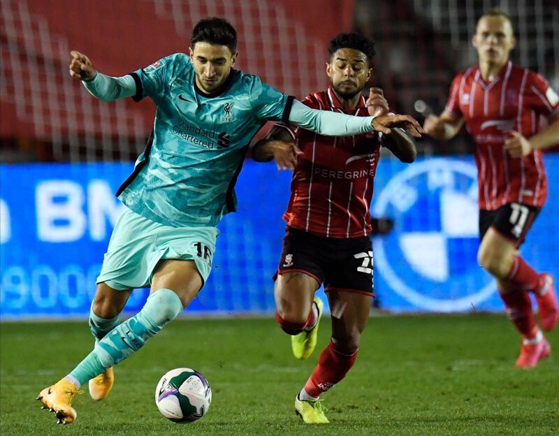 Liverpool's Marko Grujic against Lincoln City's Liam Bridcutt. EPA