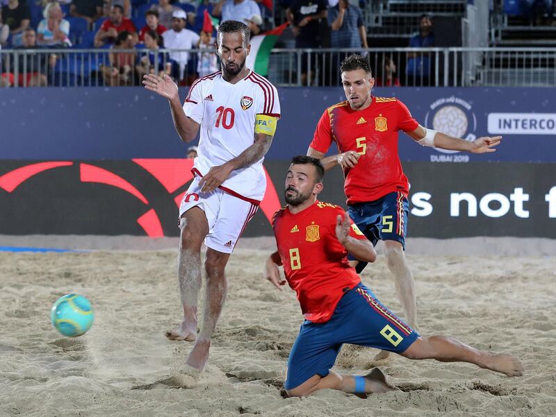 Dubai, United Arab Emirates - November 05, 2019: The UAE's Walid Mohammad and Spain's Adrian Frutos Garcia battle during the game between the UAE and Spain during the Intercontinental Beach Soccer Cup. Tuesday the 5th of November 2019. Kite Beach, Dubai. Chris Whiteoak / The National