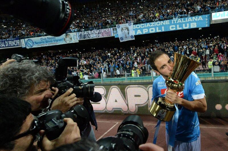 Napoli forward Gonzalo Higuain celebrates with the Coppa Italia trophy prior their Serie A match against Cagliari on Tuesday. Ciro Fusco / EPA / May 6, 2014  