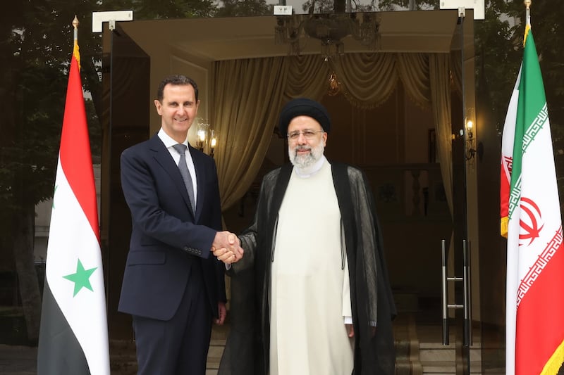Mr Raisi, right, greets his Syrian counterpart Bashar Assad in Tehran, on May 8, 2022. EPA 