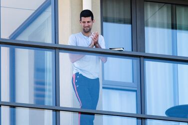 epa08947619 Novak Djokovic on the balcony of the M Suites accomodation, where some Australian Open competitors are currently under quarantine after testing positive for Covid-19, in North Adelaide, Australia, 19 January 2021. Victoria's premier has bluntly rejected tennis star Novak Djokovic's reported demands to ease lockdown restrictions as the number of Australian Open competitors in quarantine reached 72. Djokovic had reportedly asked that all players under quarantine be moved into private houses with tennis courts. EPA/MORGAN SETTE AUSTRALIA AND NEW ZEALAND OUT