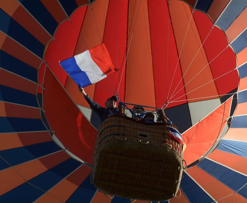The French flag is waved as the "Scy-chazelle" balloon launches. AP Photo