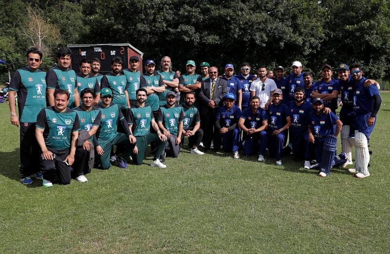 Pakistan and India teams pose for a photo.