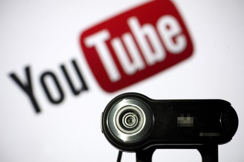 (FILES) In this file photo taken on June 28, 2013 a webcam is positioned in front of YouTube's logo in Paris.  Google agreed to pay a $170 million fine to settle charges that it illegally collected and shared data from children on its YouTube video service without consent of parents, US officials announced on September 4, 2019. The settlement with the Federal Trade Commission and the New York state Attorney General is the largest amount in a case involving the Children's Online Privacy Protection Act, a 1998 federal law. / AFP / LIONEL BONAVENTURE

