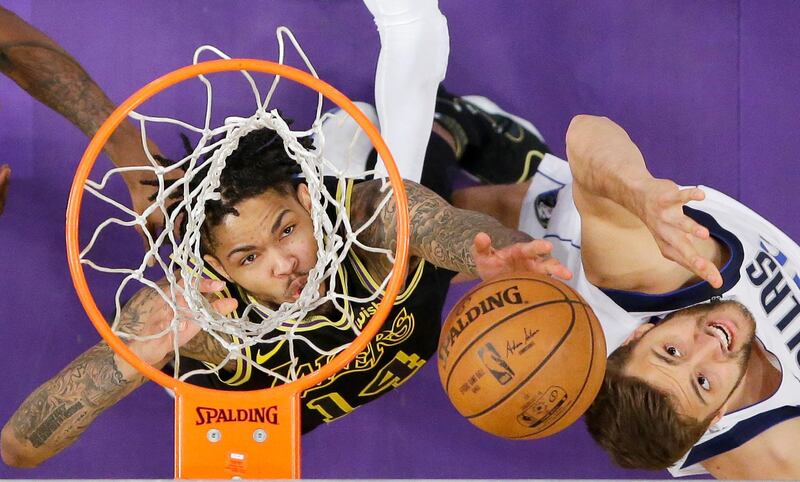 Los Angeles Lakers forward Brandon Ingram and Dallas Mavericks forward Maximilian Kleber reach for a rebound during the second half of an NBA basketball game in Los Angeles. Mark J. Terrill / AP Photo