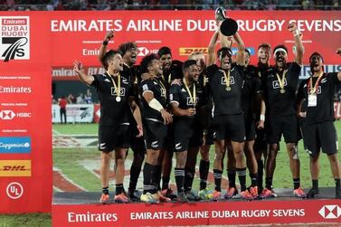 New Zealand celebrate with the trophy after winning the 2018 Dubai Rugby Sevens. AFP