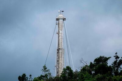 One of three concrete support towers for the Arecibo Observatory radio telescope is seen in Arecibo, Puerto Rico on November 19, 2020. The National Science Foundation (NSF) announced on November 19, 2020, it will decommission the radio telescope following two cable breaks in recent months which have brought the structure to near collapse. / AFP / Ricardo ARDUENGO
