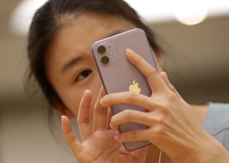 A customer tests Apple's new iPhone 11 in Beijing. Reuters