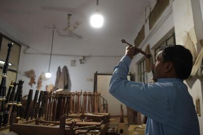 In this picture taken on January 25, 2019, a Pakistani worker prepares a component to make a set of bagpipes at the Mid East bagpipe factory in the eastern city of Sialkot. Umer Farooq's grandfather and father made bagpipes. Now he is the third generation to take up the tradition in Pakistan, which is thousands of kilometres from Scotland yet sells thousands of bagpipes each year. 
 - TO GO WITH: Pakistan-music-bagpipes, FEATURE by Joris FIORITI
 / AFP / AAMIR QURESHI / TO GO WITH: Pakistan-music-bagpipes, FEATURE by Joris FIORITI
