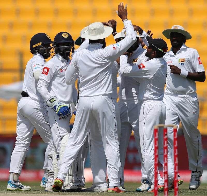 Sri Lanka players celebrate after dismissal of Pakistan's Sami Aslam during their fifth day at First Test cricket match against in Abu Dhabi, United Arab Emirates, Monday, Oct. 2, 2017. (AP Photo/Kamran Jebreili)
