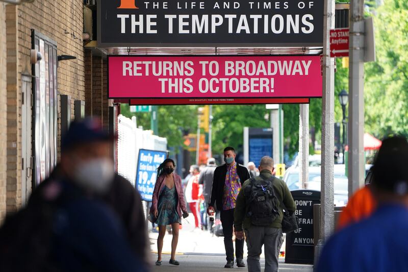 People walk past Broadway show marquees amid the pandemic in New York City on May 13, 2021. Reuters