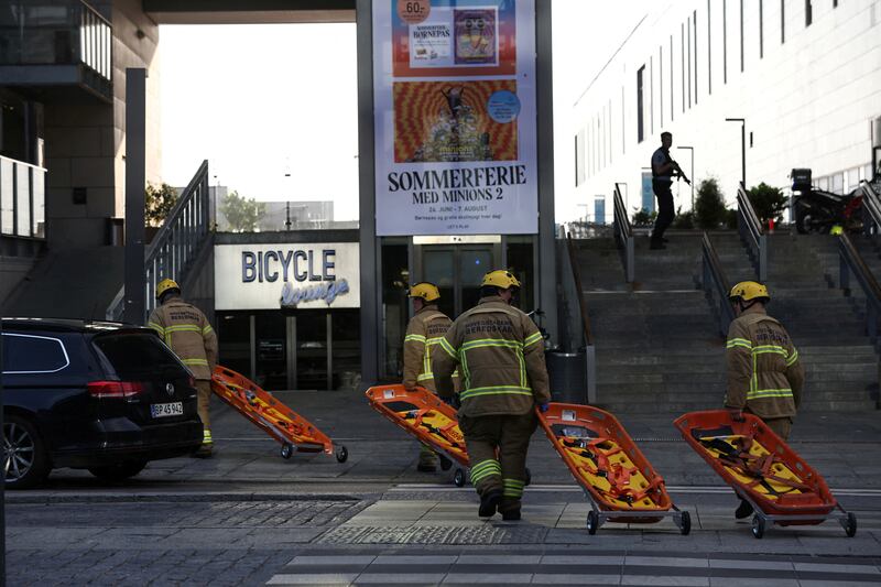 Rescuers carry stretchers as they head into the mall. Reuters