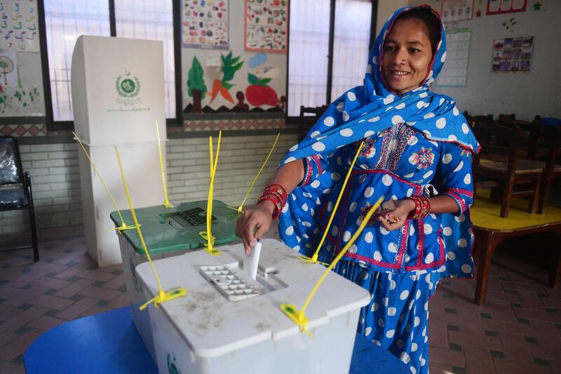 A woman casts her ballot at a polling station during Pakistan's national elections. AFP