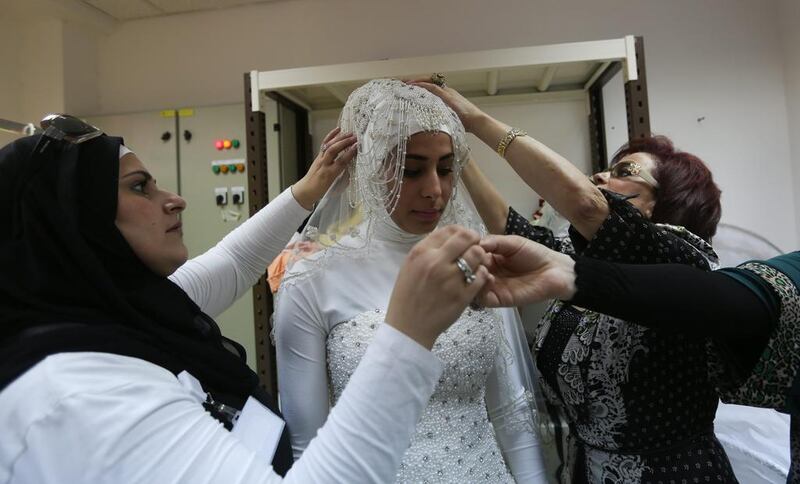 A Palestinian model prepares backstage before showing a wedding dress by Palestinian designer Intisar Abdo.  EPA