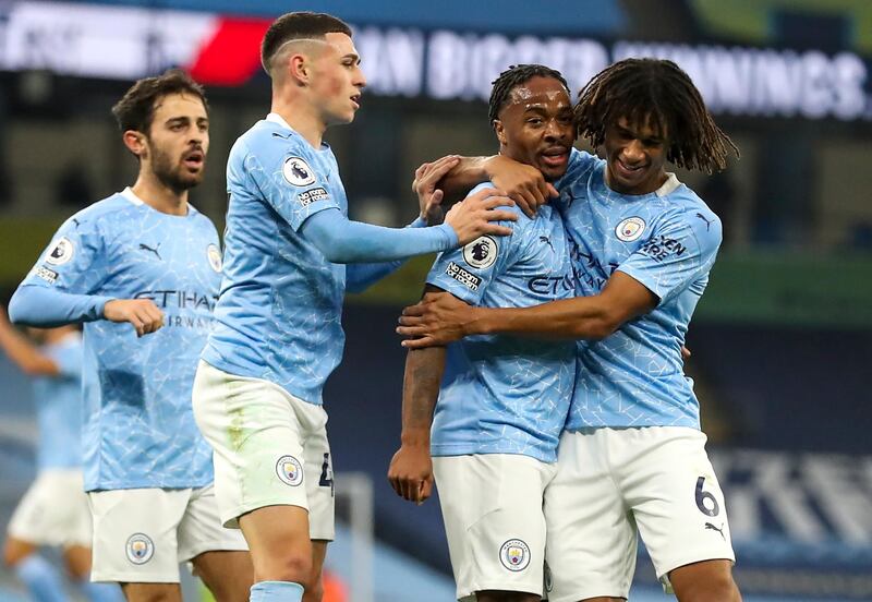 Raheem Sterling, second right, celebrates after scoring what turned out to be the winning goal in the first half against Arsenal at the Etihad Stadium on Saturday. EPA