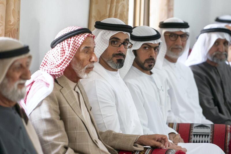 AL AIN, UNITED ARAB EMIRATES - January 19, 2019: HH Major General Sheikh Khaled bin Mohamed bin Zayed Al Nahyan, Deputy National Security Adviser (3rd L) and HH Sheikh Khalifa bin Tahnoon bin Mohamed Al Nahyan, Director of the Martyrs' Families' Affairs Office of the Abu Dhabi Crown Prince Court (4th L), visits the house of Matar Khalfan Al Neyadi (L).

( Mohamed Al Hammadi / Ministry of Presidential Affairs )
---