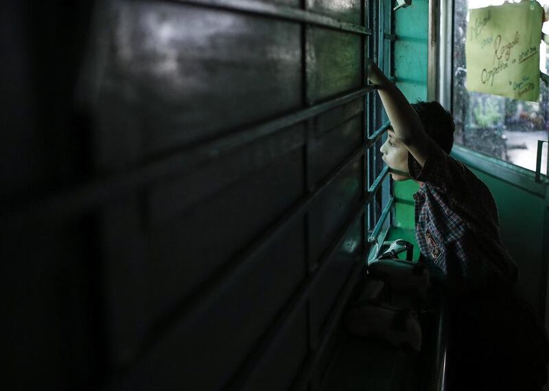 A boy who was born with a mental disability looks out of a window at a rehabilitation centre supported by Bhopal Medical Appeal for children who were born with mental and physical disabilities in Bhopal.