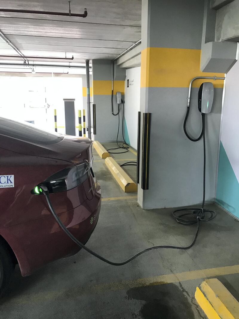 Charging a Tesla Model S in Al Ain during the EVRT Middle East 2019. Adam Workman / The National