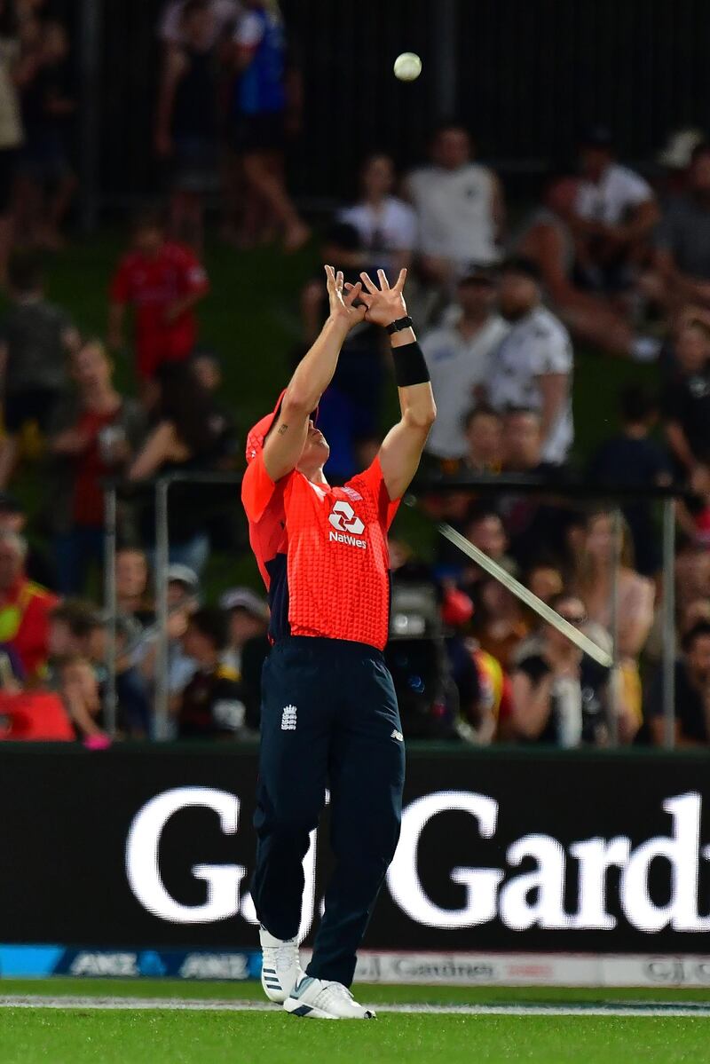 England's Tom Curran, left, catches out New Zealand batsman Tim Seifert. AFP