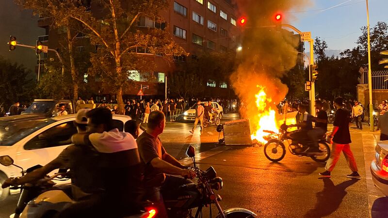 A fire burns in the street during a protest in Tehran on September 19, three days after the death of Mahsa Amini in police custody. Reuters