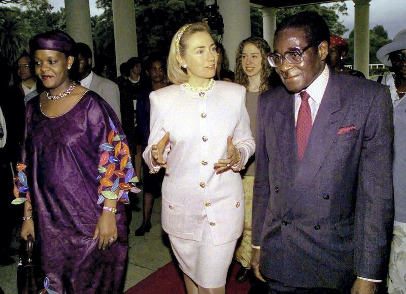 FILE PHOTO:  U.S. First Lady Hillary Clinton (C) is escorted by Zimbabwe's President Robert Mugabe (R) and his wife Grace Mugabe after she arrived at the presidential palace in Harare March 21, 1997.  REUTERS/Win McNamee/File Photo