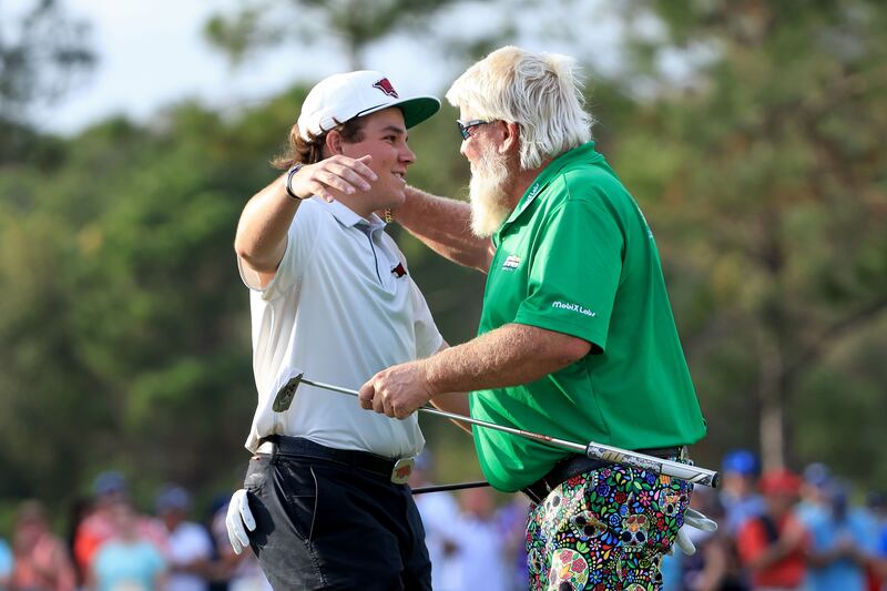 John Daly and John Daly II celebrate on the 18th green after winning the PNC Championship. AFP