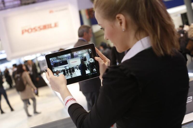 An employee demonstrates a Huawei MediaPad tablet at the Huawei Technologies pavilion during Mobile World Congress in Barcelona. Simon Dawson / Bloomberg