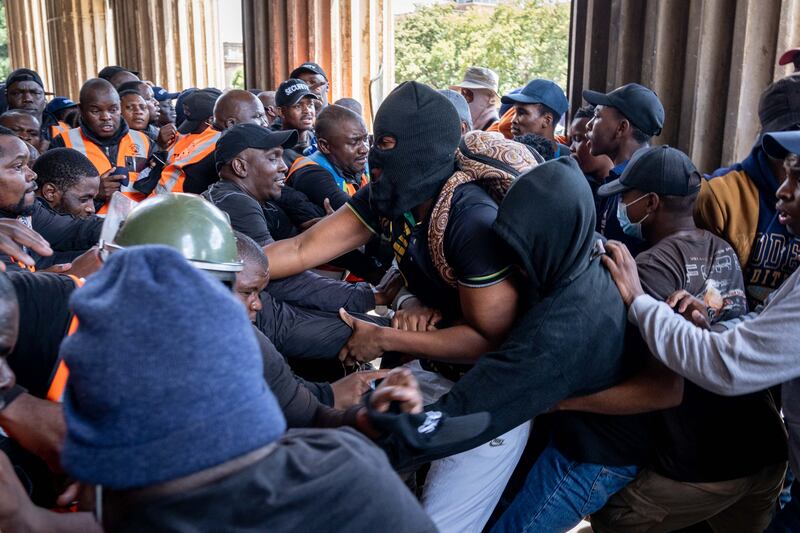 Students clash with security officers as they attempt to storm the Great Hall at the University of Witwatersrand in Johannesburg. AFP