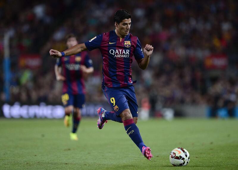 Barcelona forward Luis Suarez plays during their friendly against Leon on Monday night at the Camp Nou. Josep Lago / AFP  